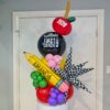 Personalized first-day balloon table topper with custom pencil, grade balloon, apple and colourful accents.