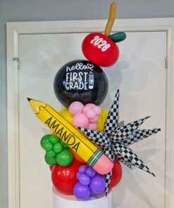 Personalized first-day balloon table topper with custom pencil, grade balloon, apple and colourful accents.