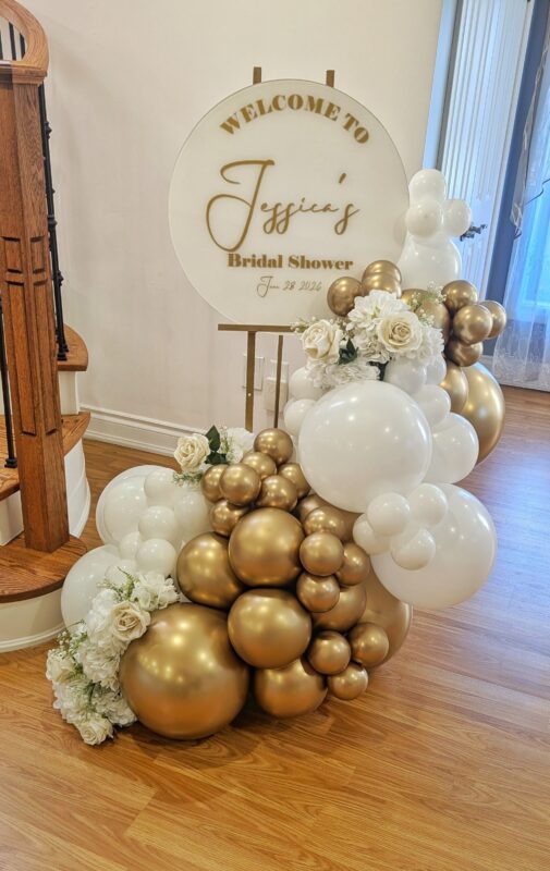 Custom Jessica bridal shower welcome sign with white and Reflex Gold balloons and faux flowers.