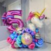 Colourful unicorn birthday number stack with disco ball balloons, twisted accents, and a personalized name decal.