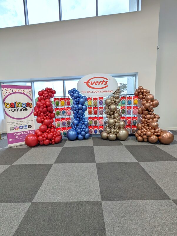 Wide view of the Everts product launch display with four organic Luxe balloon columns.