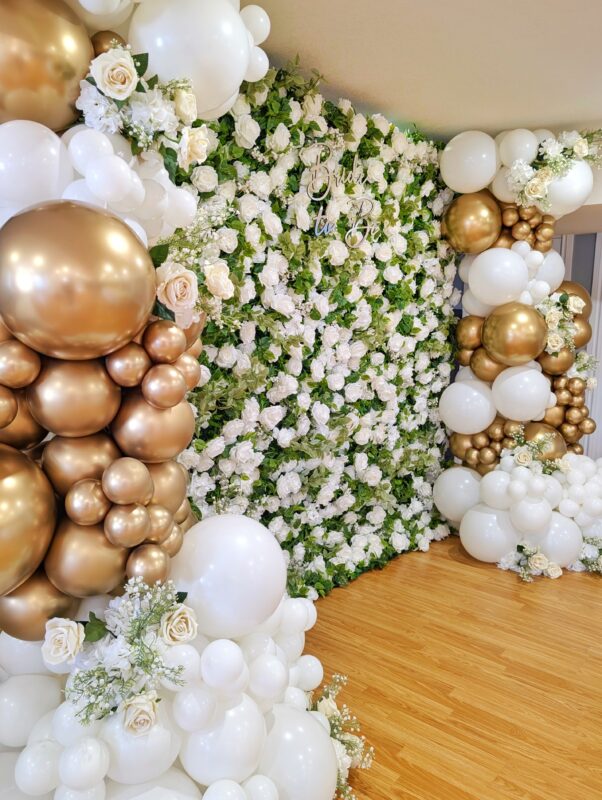 White floral wall with organic white and Reflex Gold balloon décor in a Brantford home