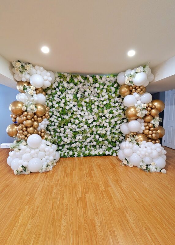 Full white floral backdrop with white and Reflex Gold organic balloon installations
