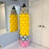 Giant yellow pencil balloon column with a pink eraser, silver band, neutral tip, and black balloon point.