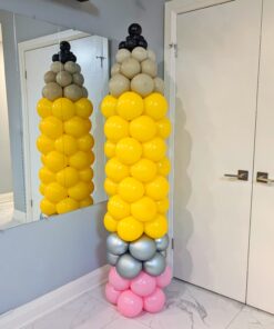 Giant yellow pencil balloon column with a pink eraser, silver band, neutral tip, and black balloon point.