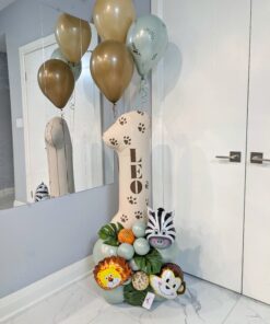 Safari birthday number stack with jungle animals, tropical leaves, sage balloons, paw prints, and a personalized name decal.