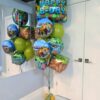 Minecraft birthday balloon bouquet with themed foil balloons and green and gold latex balloons.