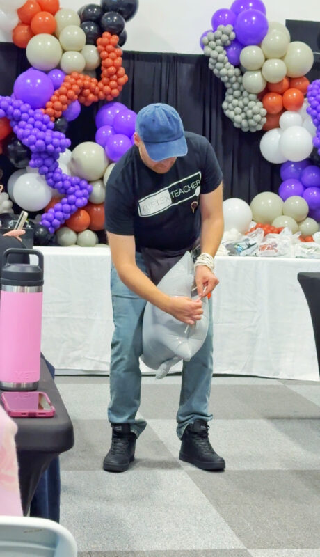 Instructor preparing a silver foil ghost during the Halloween balloon class