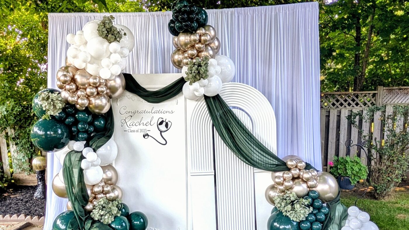 Rachel's respiratory therapy graduation balloon backdrop in deep green, champagne and white.
