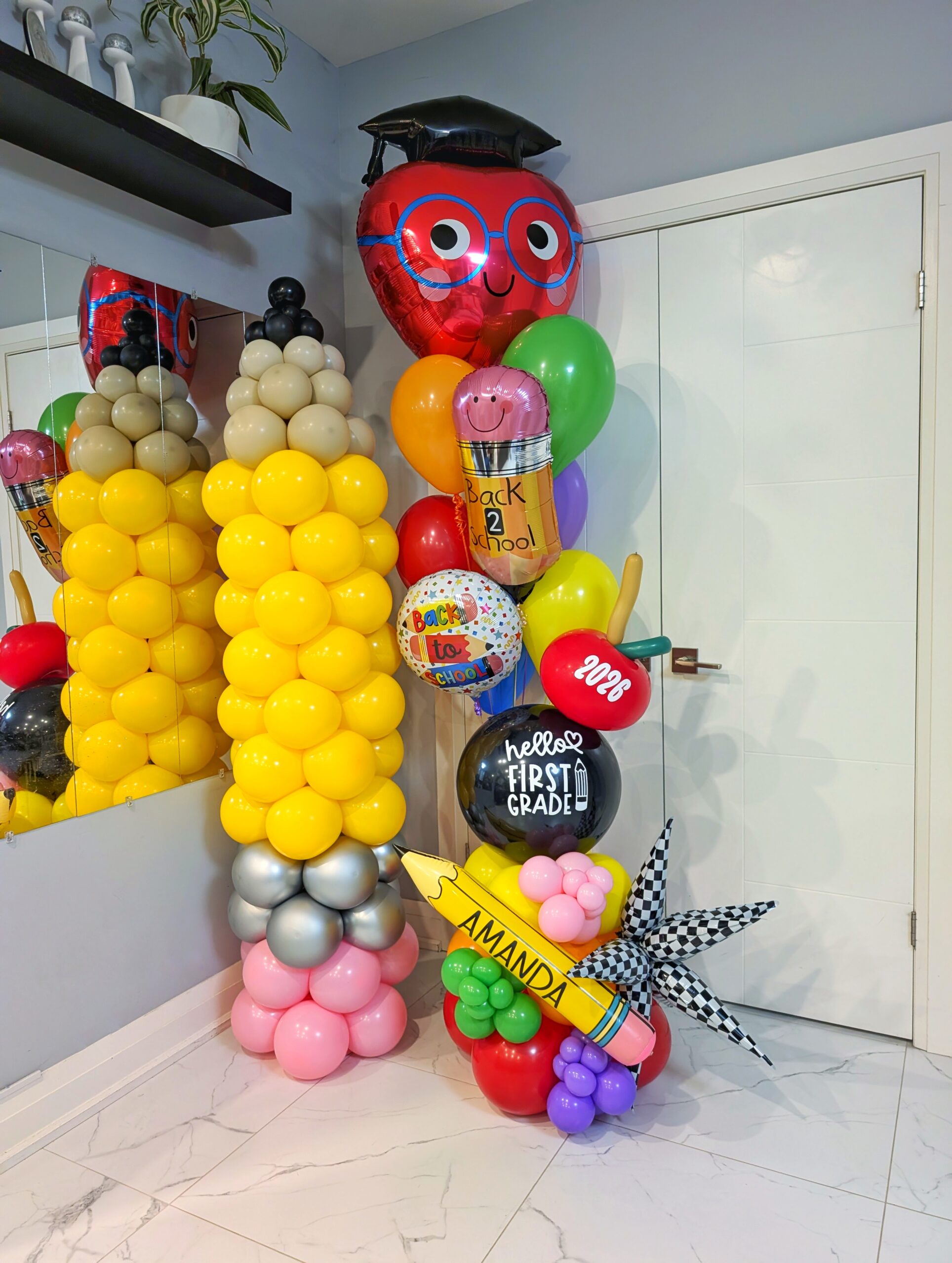 Two-piece back-to-school balloon bundle with a giant pencil column and personalized school-themed balloon display.