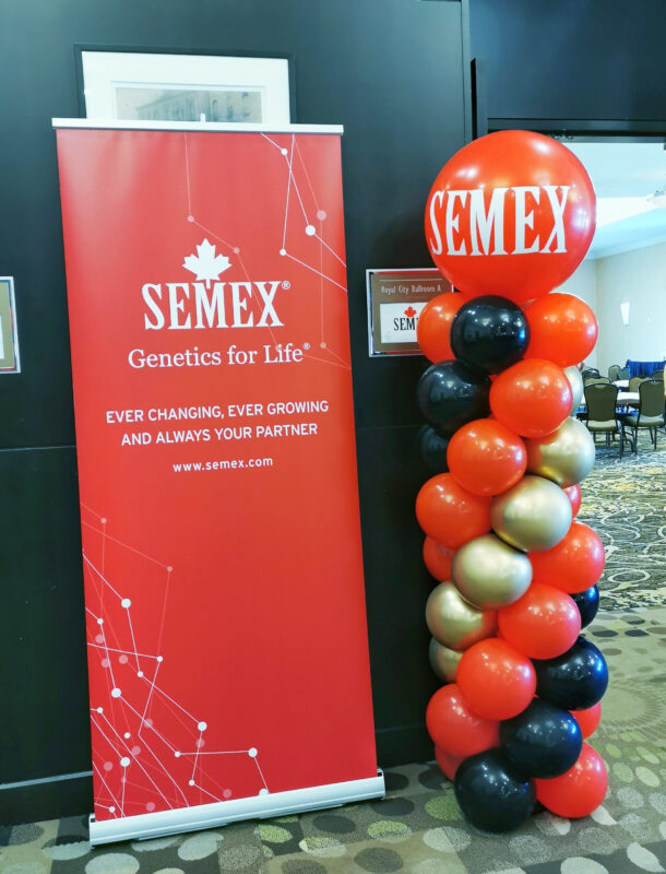 Semex corporate banner paired with a branded red, black and gold balloon column at the Guelph event.