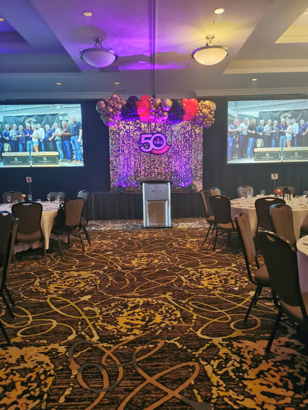 Banquet room view of the Semex 50th anniversary stage and branded corporate event décor in Guelph