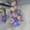 Large unicorn birthday balloon bouquet with rainbow, disco ball, themed foil, and colourful latex balloons.